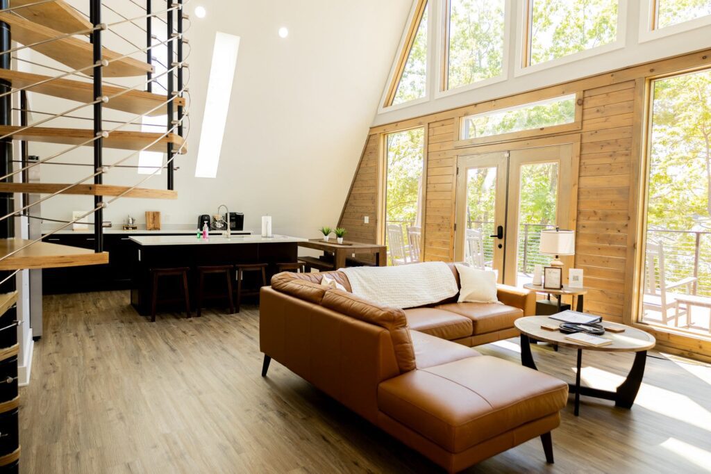 Living room with a leather sectional and the window wall